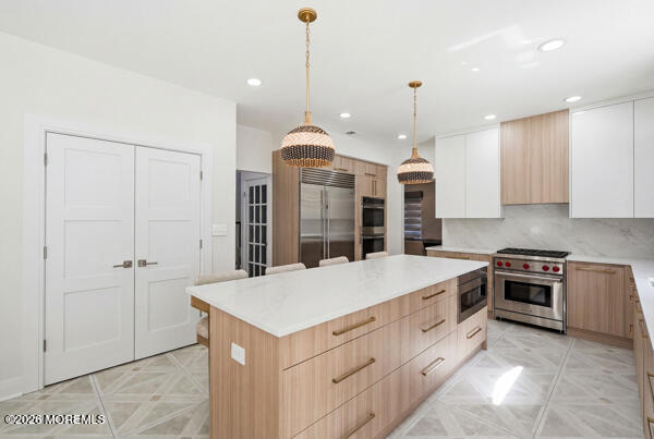 54 Georgetown Road Eatontown, NJ 07724 - Photo 6 of 24 a large kitchen with kitchen island a stove a sink a center island a stove and a window