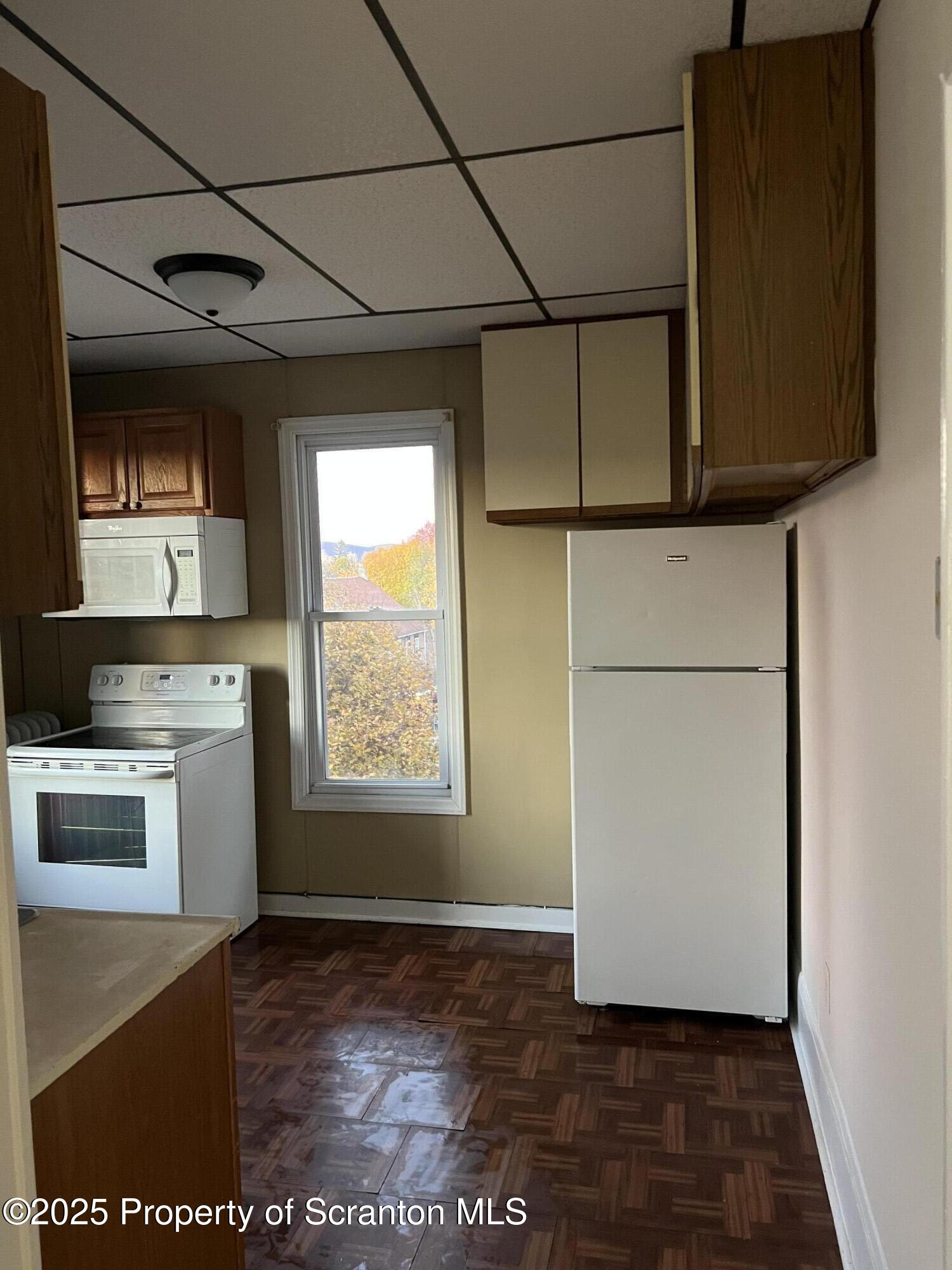 1330 Pittston Avenue, Unit 2N Scranton, PA 18505 - Photo 1 of 12 a view of a kitchen with a sink and dishwasher