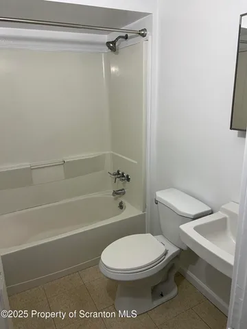 a bathroom with a toilet and shower