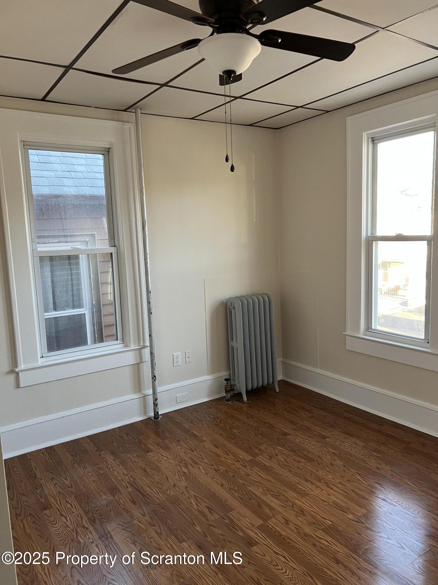 1330 Pittston Avenue, Unit 2N Scranton, PA 18505 - Photo 7 of 12 a view of an empty room with a window and wooden floor
