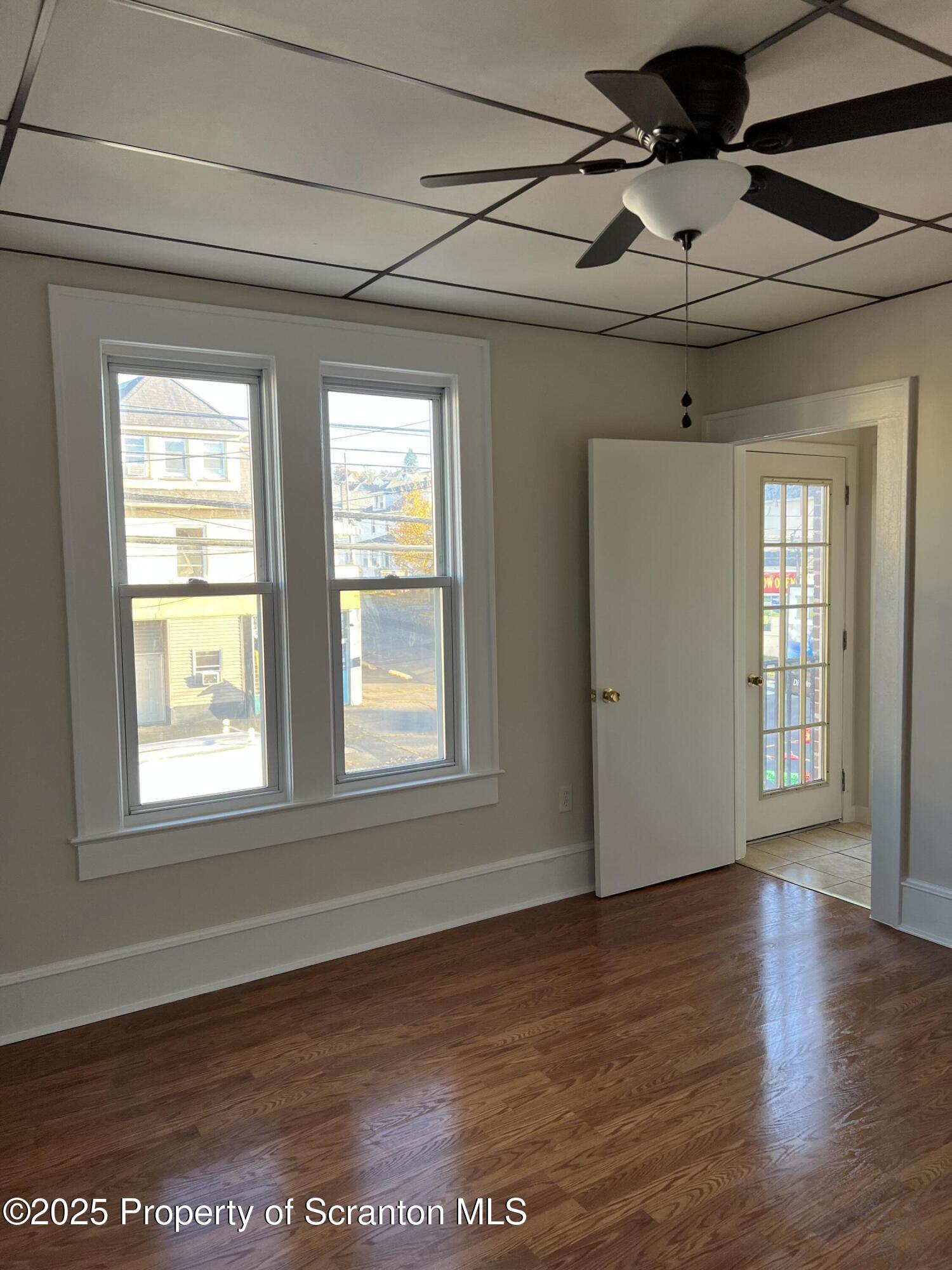 1330 Pittston Avenue, Unit 2N Scranton, PA 18505 - Photo 8 of 12 a view of an empty room with wooden floor and a window