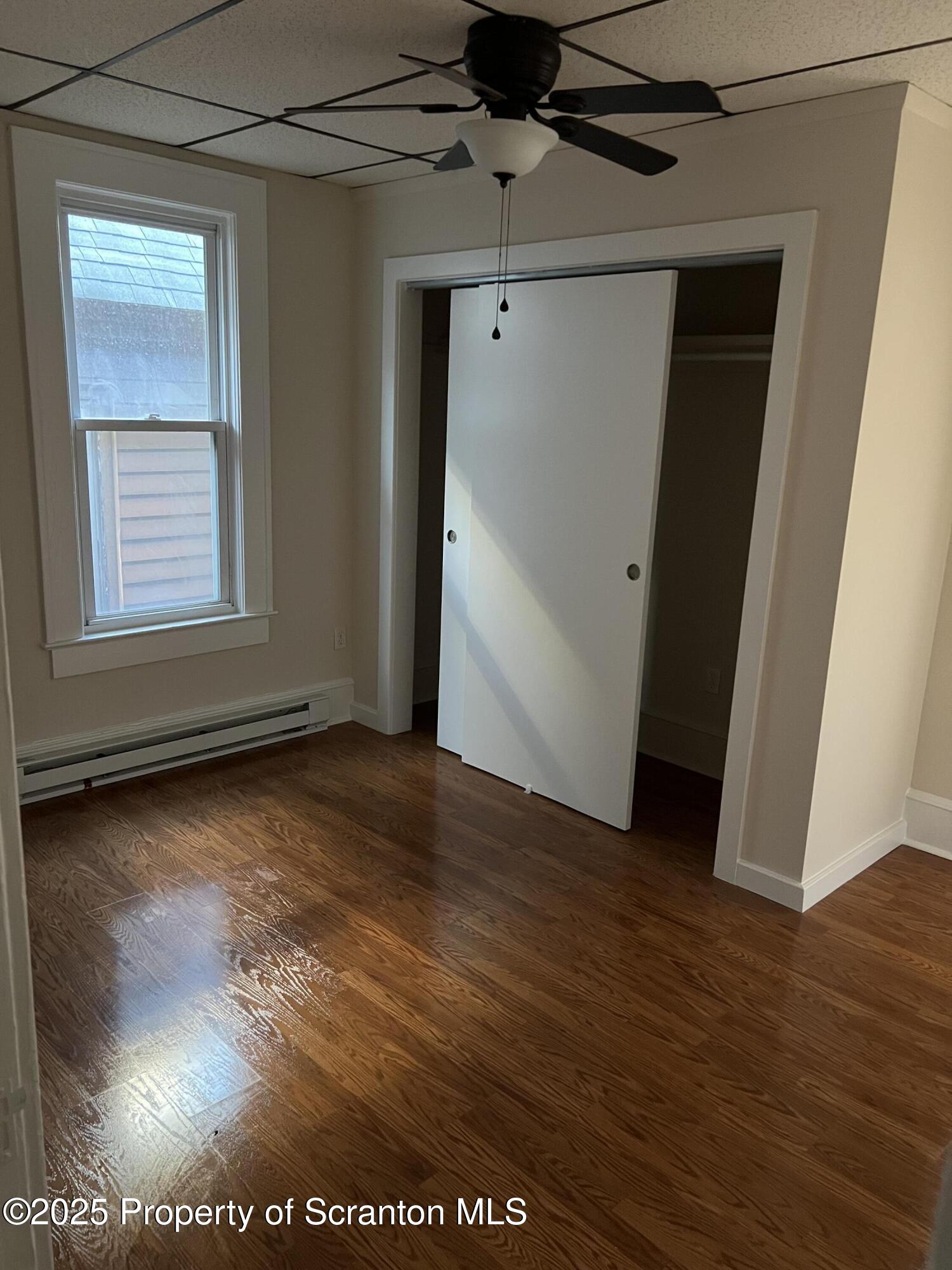 1330 Pittston Avenue, Unit 2N Scranton, PA 18505 - Photo 10 of 12 an empty room with wooden floor and windows