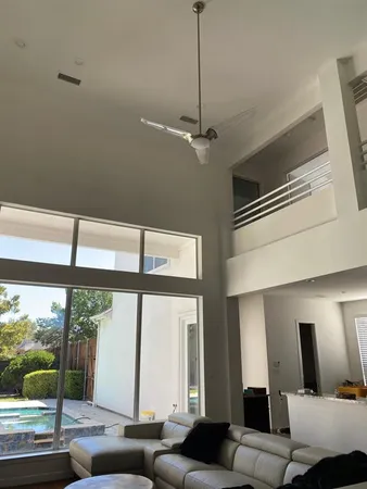 a living room with furniture and large windows