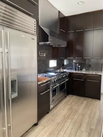 a kitchen with a stove sink and cabinets