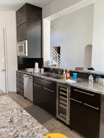 a kitchen with a sink cabinets and stainless steel appliances