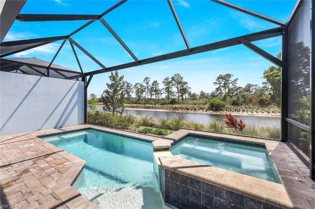 6895 Saona Court Naples, FL 34113 - Photo 17 of 33 a view of a lake from a balcony with furniture