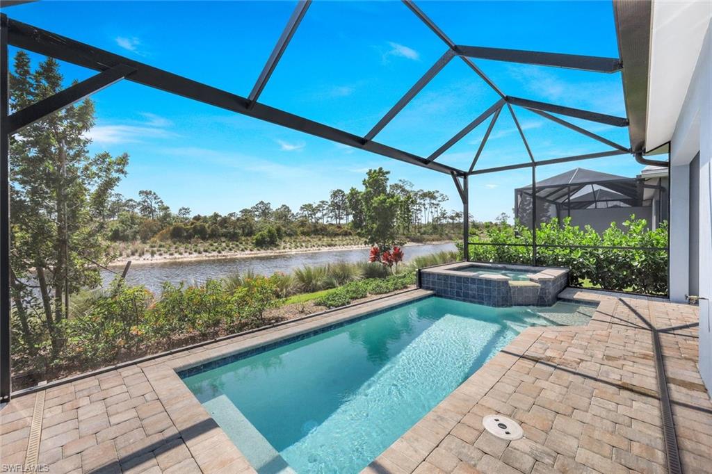 6895 Saona Court Naples, FL 34113 - Photo 18 of 33 a view of swimming pool with a patio