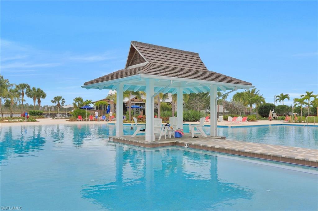 6895 Saona Court Naples, FL 34113 - Photo 27 of 33 a roof deck with table and chairs and potted plants