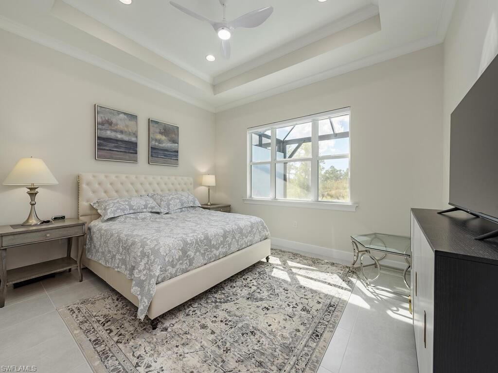 6895 Saona Court Naples, FL 34113 - Photo 8 of 33 a bedroom with a bed and a window