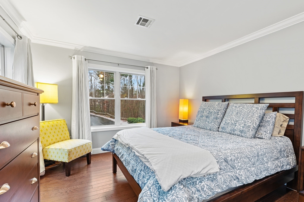 24 Shayne Road, Unit 219 Franklin, MA 02038 - Photo 12 of 23 a bedroom with a bed and wooden floor