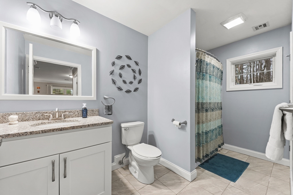 24 Shayne Road, Unit 219 Franklin, MA 02038 - Photo 14 of 23 a bathroom with a toilet a sink and mirror