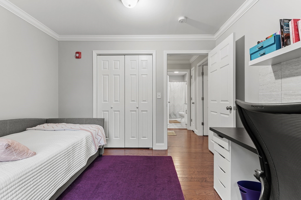 24 Shayne Road, Unit 219 Franklin, MA 02038 - Photo 16 of 23 a bed room with a bed and a mirror