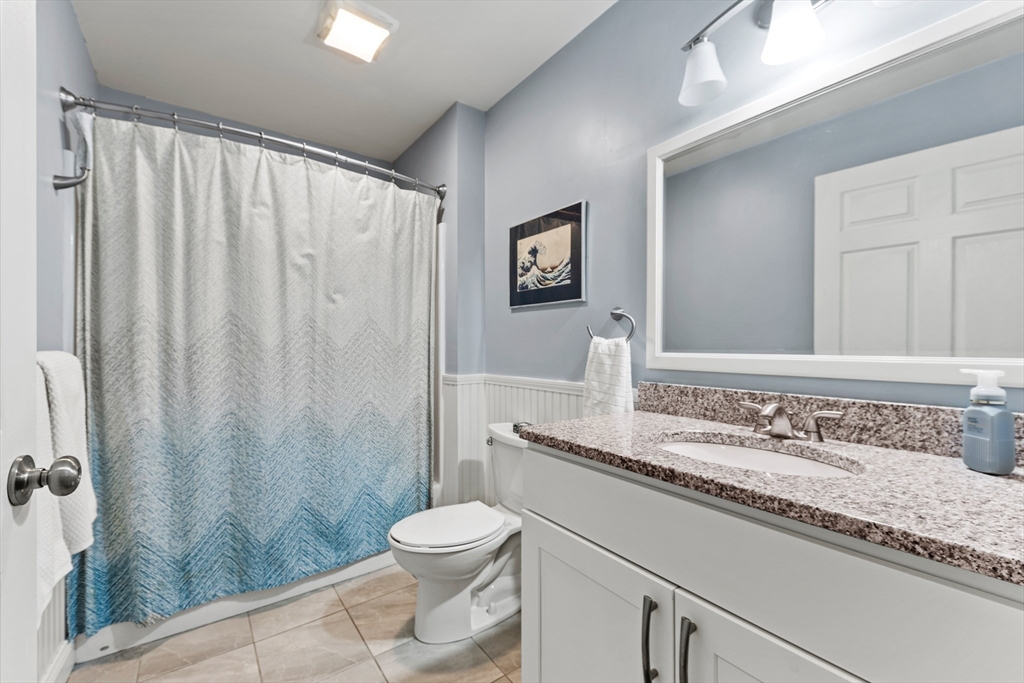 24 Shayne Road, Unit 219 Franklin, MA 02038 - Photo 17 of 23 a bathroom with a granite countertop sink and a mirror