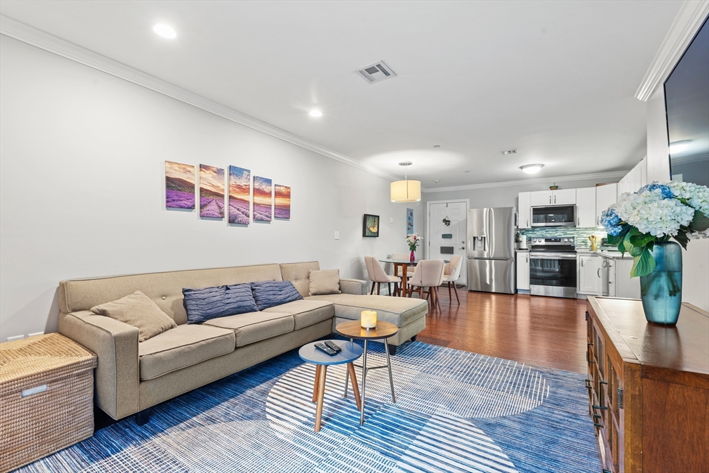 24 Shayne Road, Unit 219 Franklin, MA 02038 - Photo 5 of 23 a living room with furniture kitchen view and a wooden floor