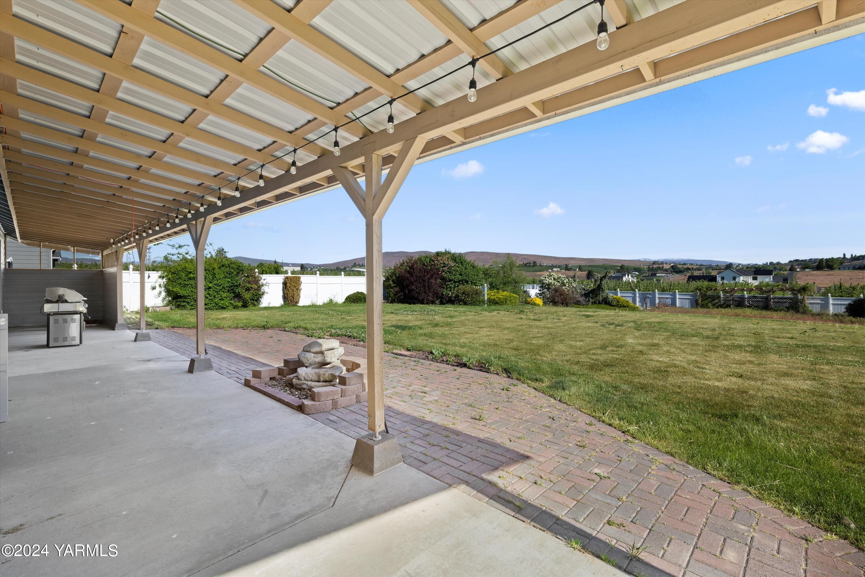 12555 West Barrett Road Yakima, WA 98908 - Photo 19 of 27 a view of a patio with a table and chairs under an umbrella