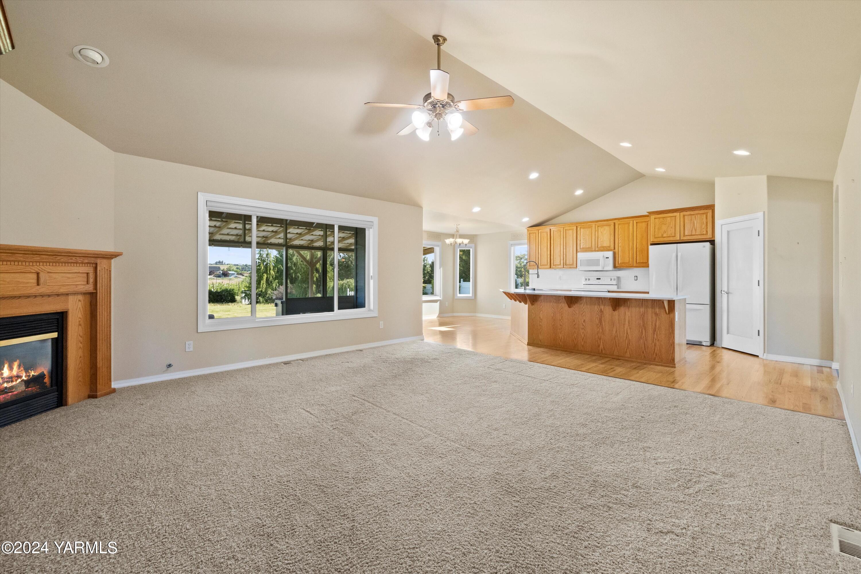 12555 West Barrett Road Yakima, WA 98908 - Photo 6 of 27 a view of an empty room with a fireplace and a window