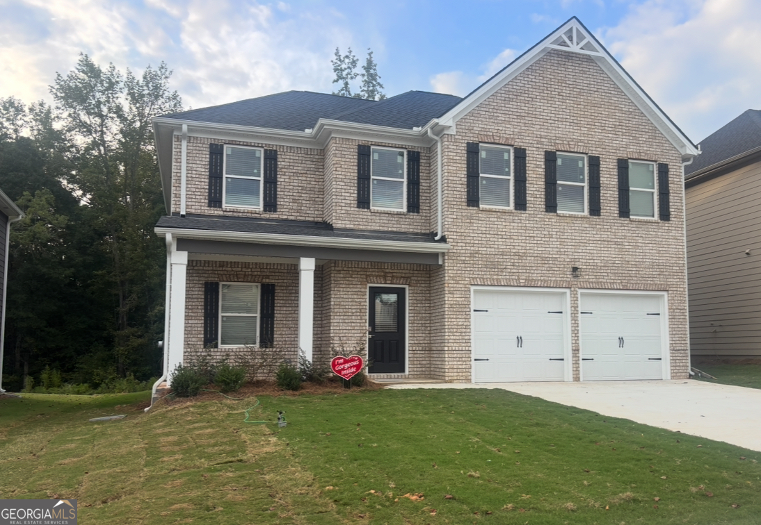 5332 Tolar Road, Unit 32 South Fulton, GA 30213 - Photo 1 of 1 a front view of a house with a yard and garage