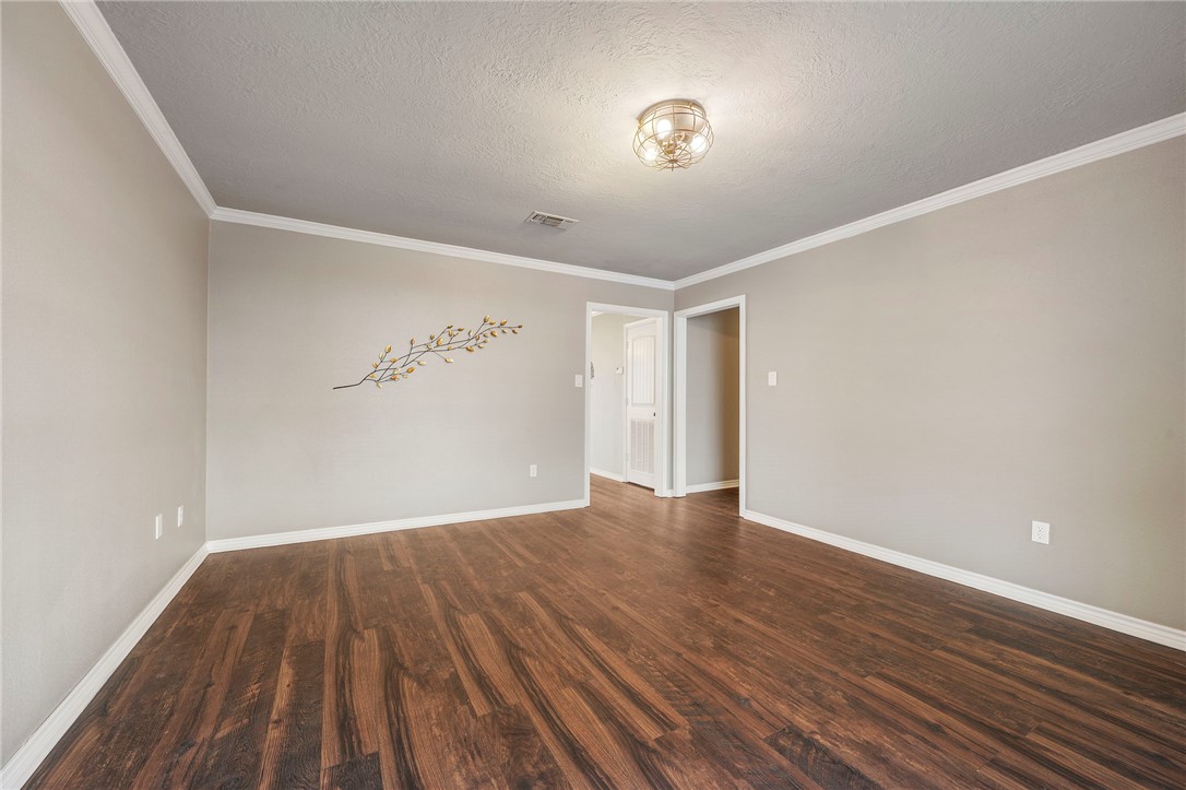3840 Mancuso Road Bryan, TX 77808 - Photo 11 of 31 a view of an empty room with wooden floor