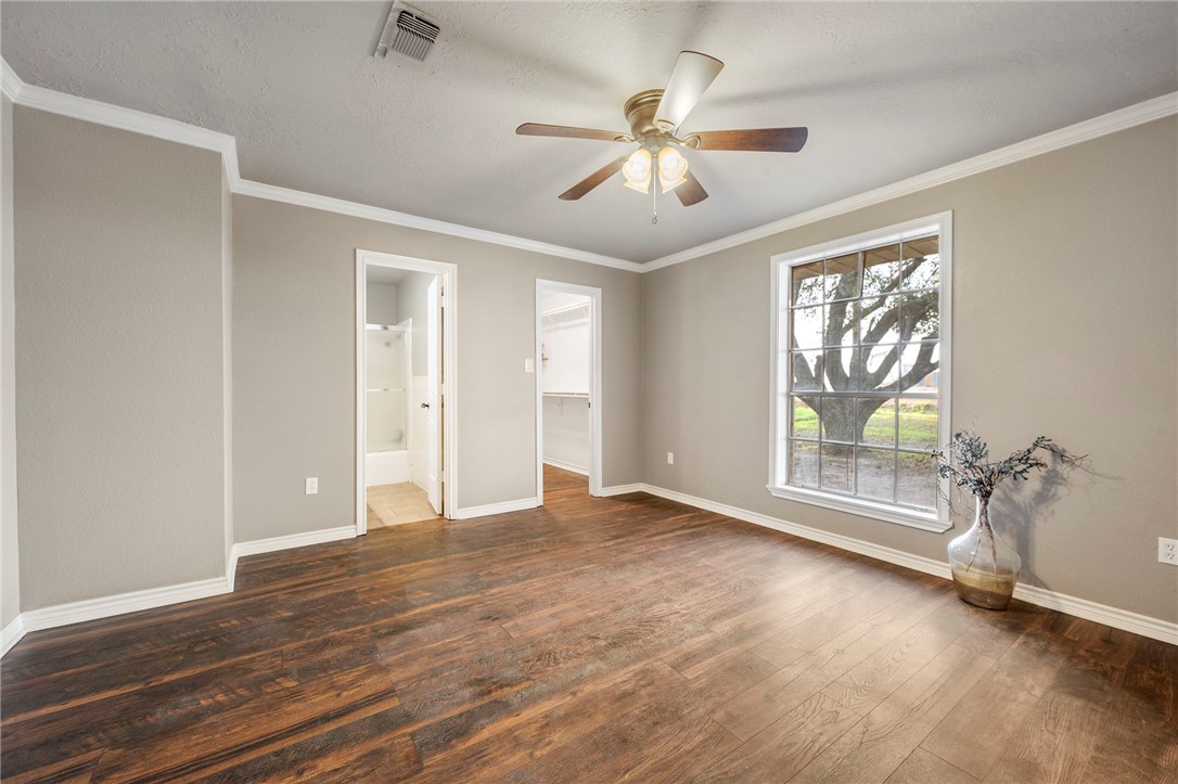 3840 Mancuso Road Bryan, TX 77808 - Photo 12 of 31 a view of an empty room with a window and wooden floor