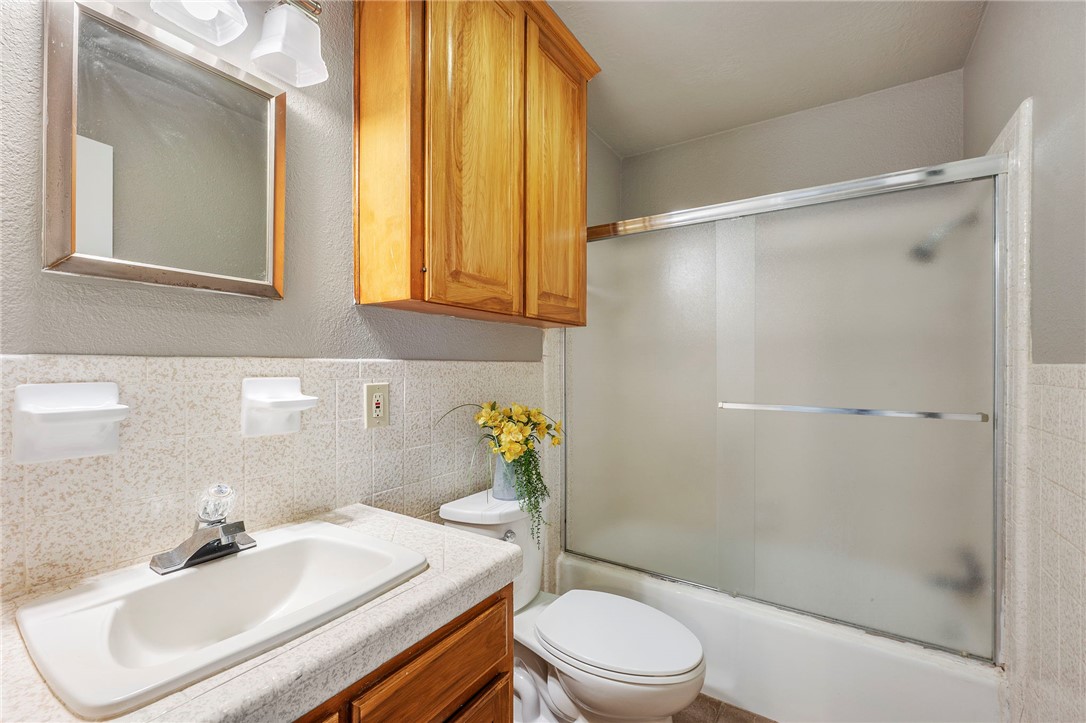 3840 Mancuso Road Bryan, TX 77808 - Photo 13 of 31 a bathroom with a sink toilet and shower