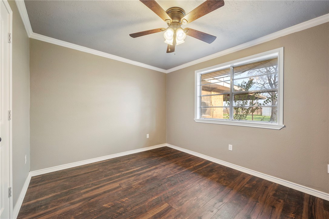 3840 Mancuso Road Bryan, TX 77808 - Photo 16 of 31 wooden floor in an empty room with a window