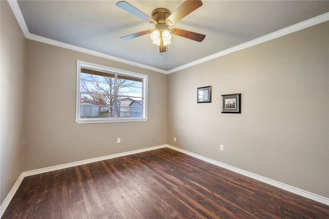 3840 Mancuso Road Bryan, TX 77808 - Photo 17 of 31 a view of room with window ceiling fan and wooden floor