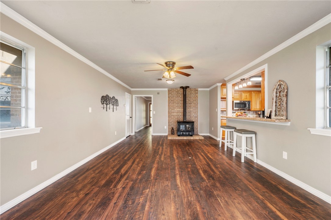 3840 Mancuso Road Bryan, TX 77808 - Photo 4 of 31 a view of a livingroom with wooden floor and a ceiling fan