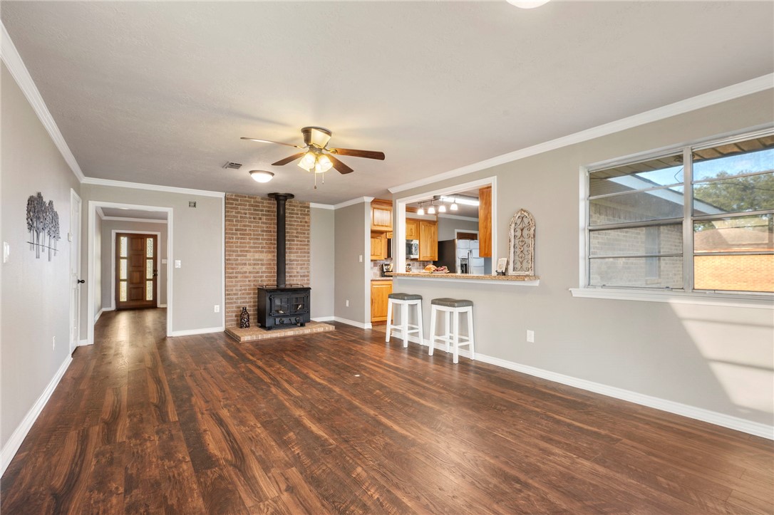 3840 Mancuso Road Bryan, TX 77808 - Photo 5 of 31 a view of a livingroom with a fireplace and wooden floor