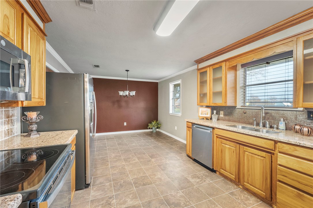3840 Mancuso Road Bryan, TX 77808 - Photo 8 of 31 a kitchen with a sink stove and cabinets
