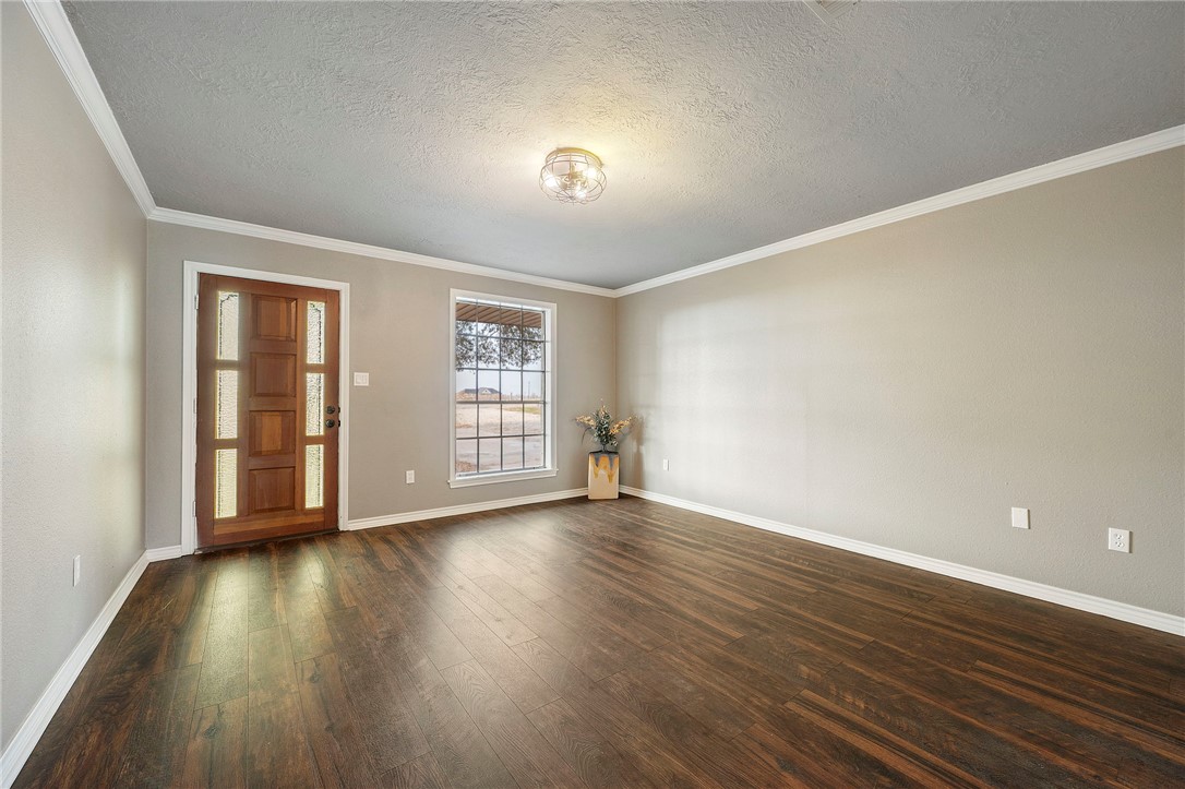 3840 Mancuso Road Bryan, TX 77808 - Photo 10 of 31 a view of an empty room with wooden floor and a window
