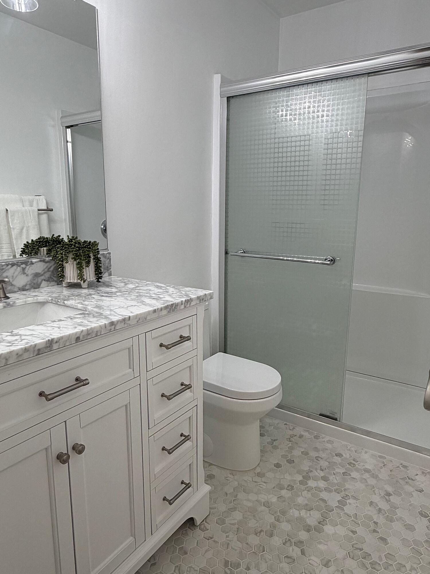4880 Sandyland Road, Unit 48 Carpinteria, CA 93013 - Photo 15 of 29 a bathroom with a granite countertop sink toilet and shower