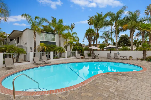 a view of a swimming pool with outdoor seating