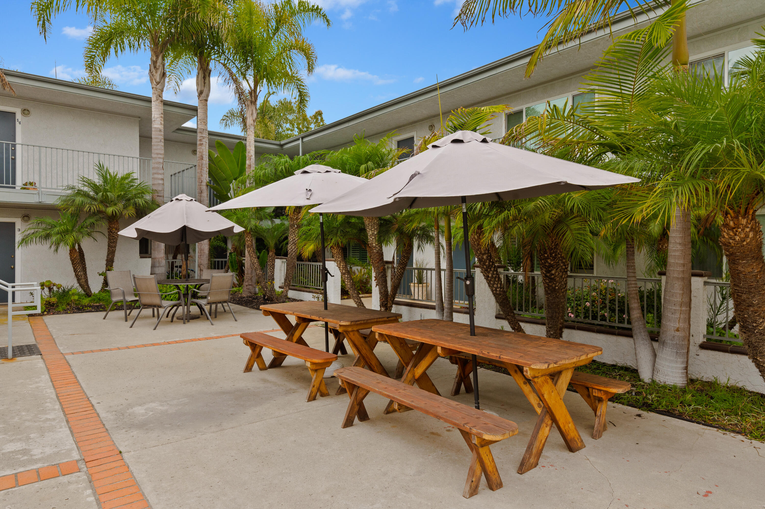 4880 Sandyland Road, Unit 48 Carpinteria, CA 93013 - Photo 21 of 29 a view of a patio with a table and chairs under an umbrella
