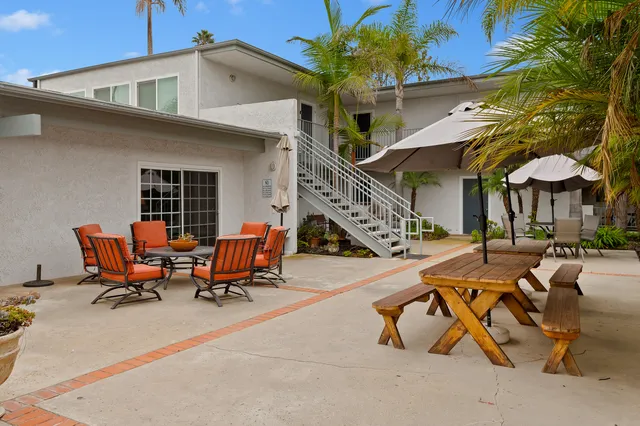 a view of a backyard with sitting area