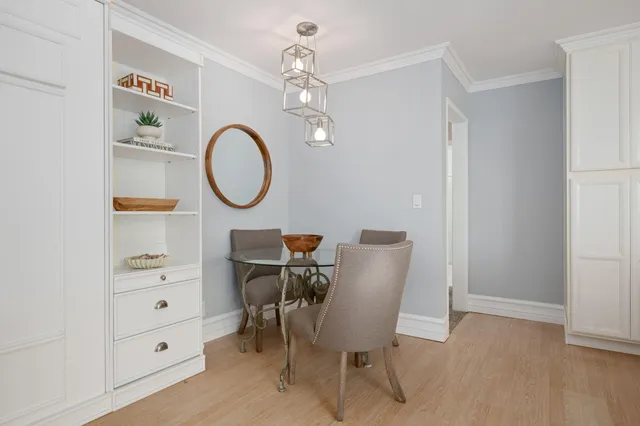 a kitchen with a sink a counter top space stainless steel appliances and cabinets
