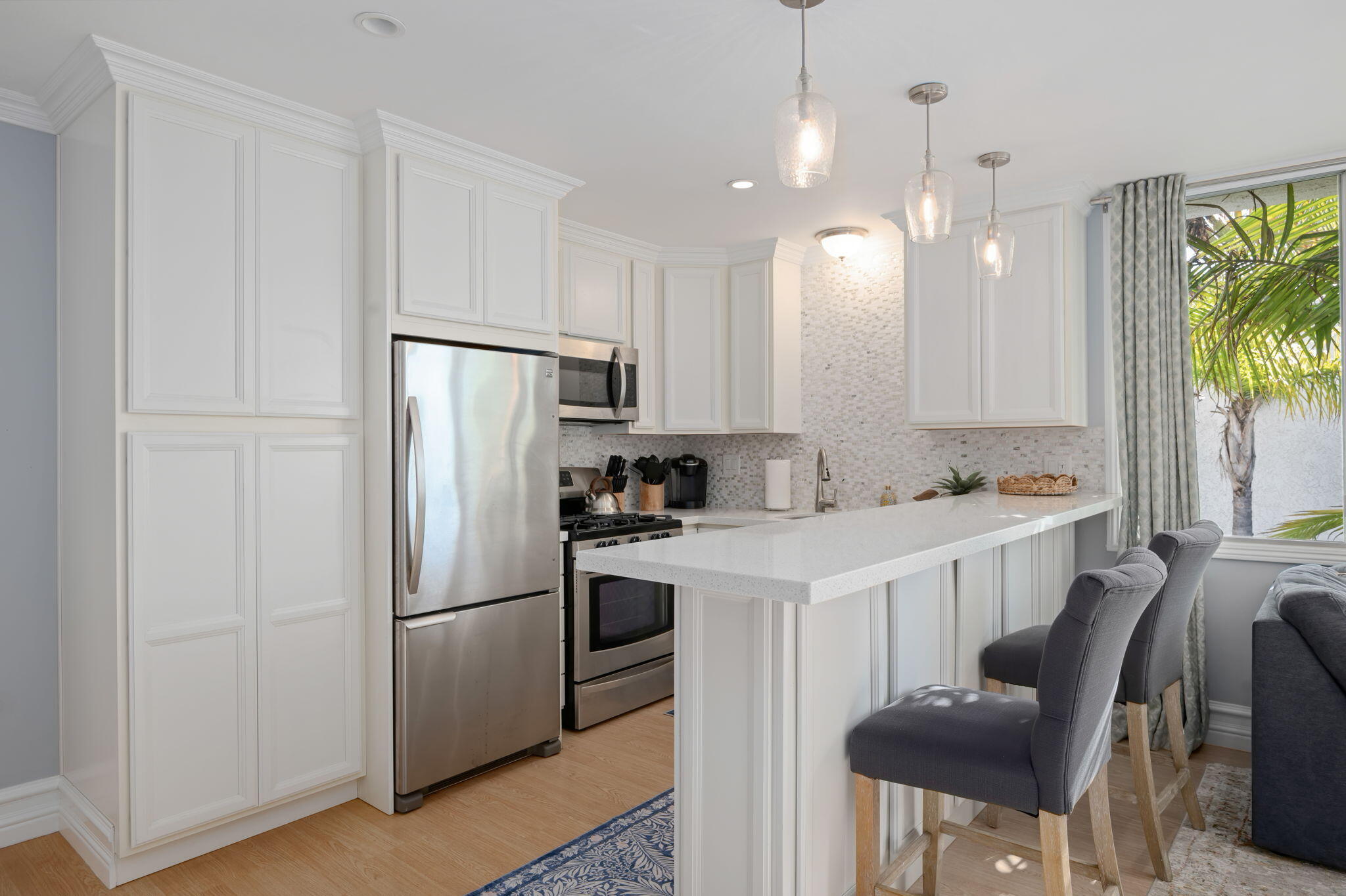 4880 Sandyland Road, Unit 48 Carpinteria, CA 93013 - Photo 9 of 29 a kitchen with a refrigerator a stove a sink and chairs