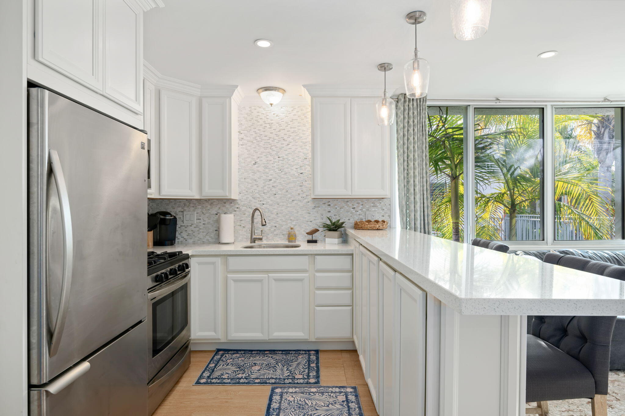 4880 Sandyland Road, Unit 48 Carpinteria, CA 93013 - Photo 10 of 29 a kitchen with a sink a counter top space stainless steel appliances and cabinets