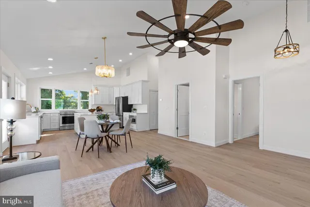 a view of a dining room with furniture a livingroom and chandelier