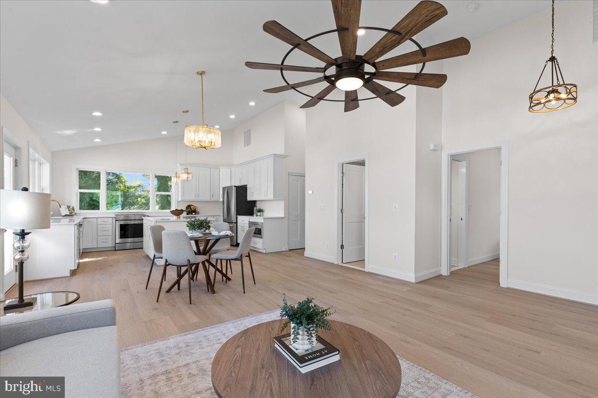2825 Ridge Road Huntingtown, MD 20639 - Photo 11 of 66 a living room with furniture dining table and a chandelier