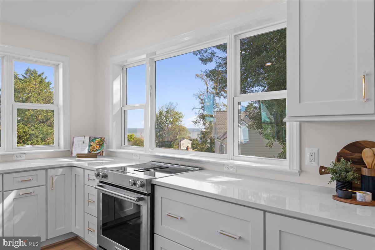 2825 Ridge Road Huntingtown, MD 20639 - Photo 19 of 66 a kitchen with stainless steel appliances white cabinets and a window