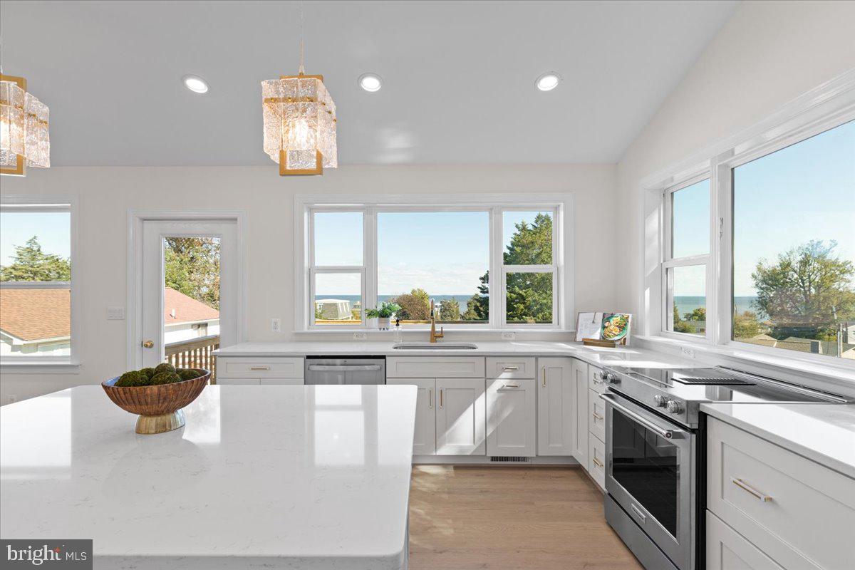 2825 Ridge Road Huntingtown, MD 20639 - Photo 22 of 67 a kitchen with a sink stainless steel appliances cabinets and a large window