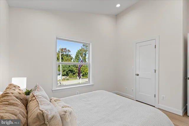 a bedroom with a bed and a potted plant