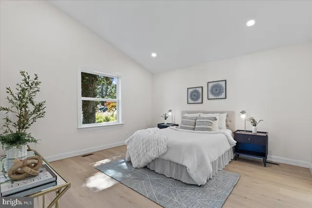 a bedroom with a large bed and a window