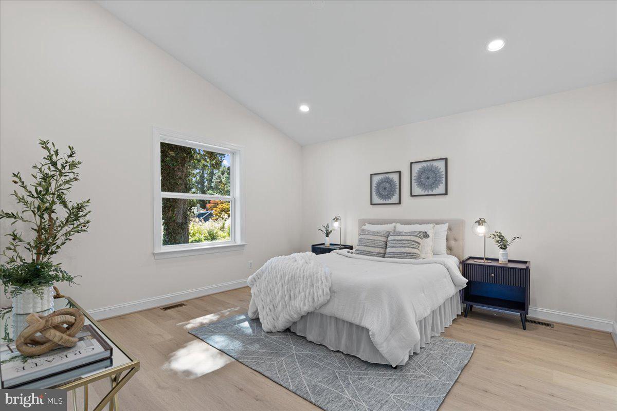 2825 Ridge Road Huntingtown, MD 20639 - Photo 28 of 67 a bedroom with a bed and a potted plant