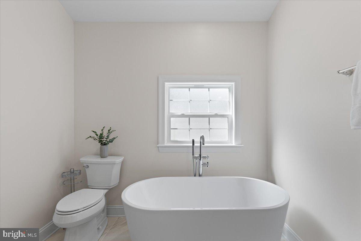 2825 Ridge Road Huntingtown, MD 20639 - Photo 35 of 67 a white toilet sitting next to a window