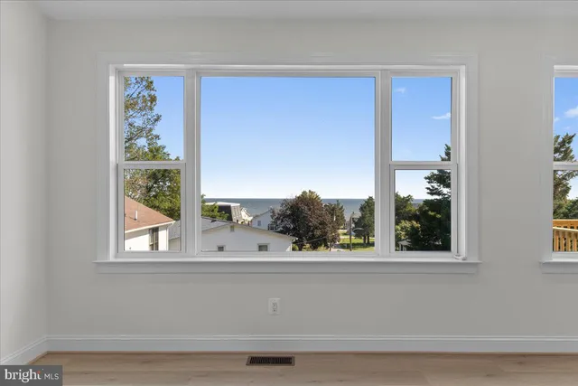 a view of backyard with barbeque grill and wooden fence