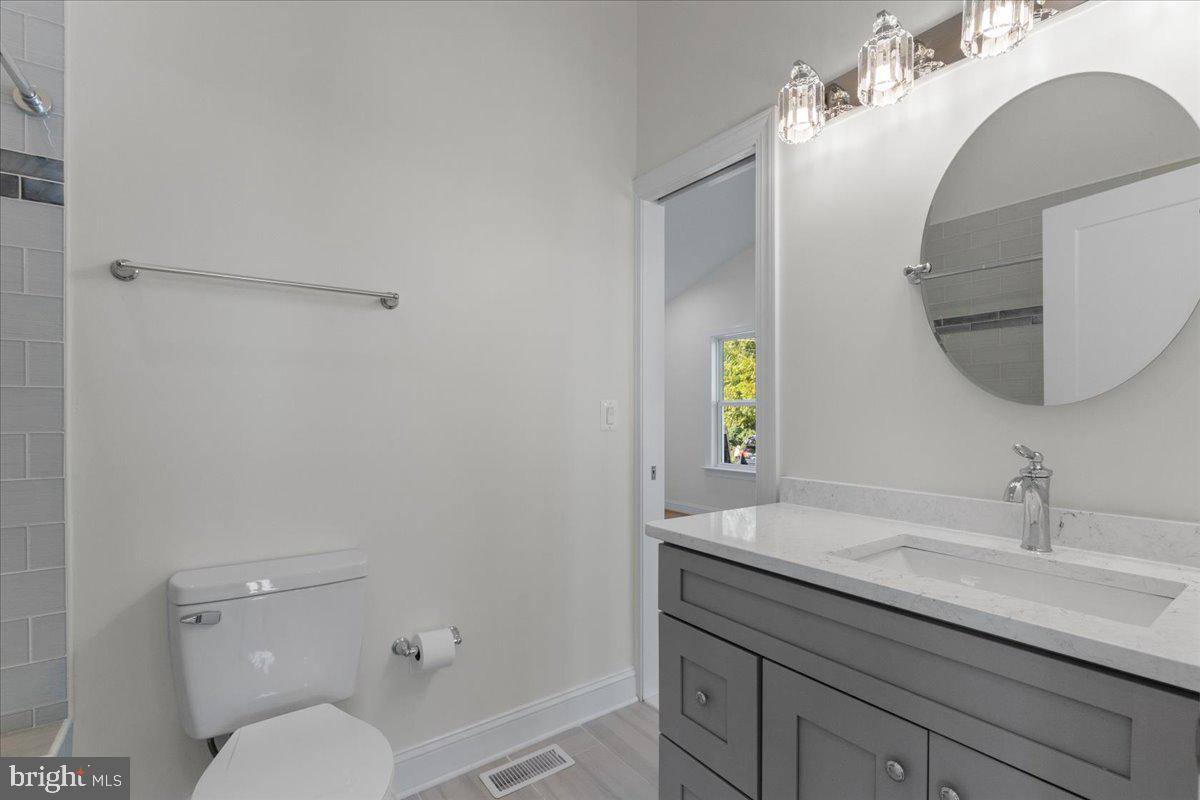 2825 Ridge Road Huntingtown, MD 20639 - Photo 43 of 66 a bathroom with a toilet a sink and mirror