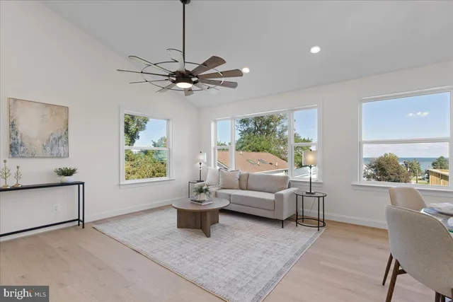 a living room with furniture dining table and a chandelier