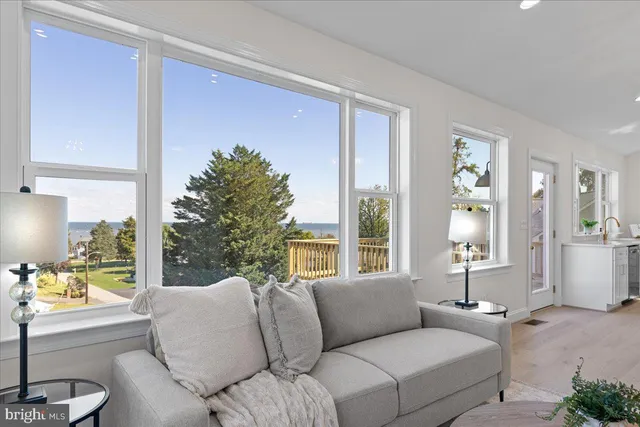 a living room with furniture dining table and a chandelier