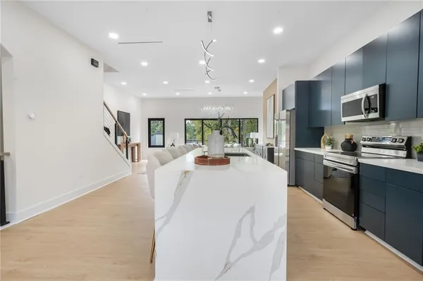 a dining table with chairs and kitchen island